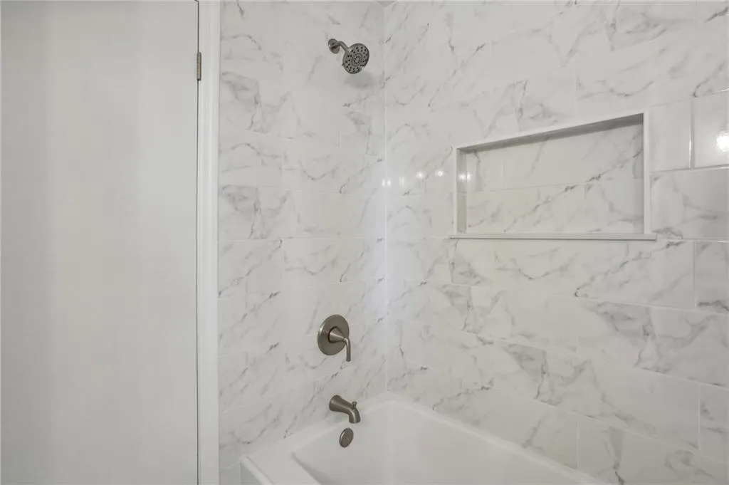 Another view of bathroom showing custom designed cutout for bath products.