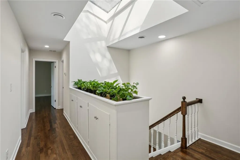 Upstairs hallway featuring skylight, built-in storage and planter for live greenery.
