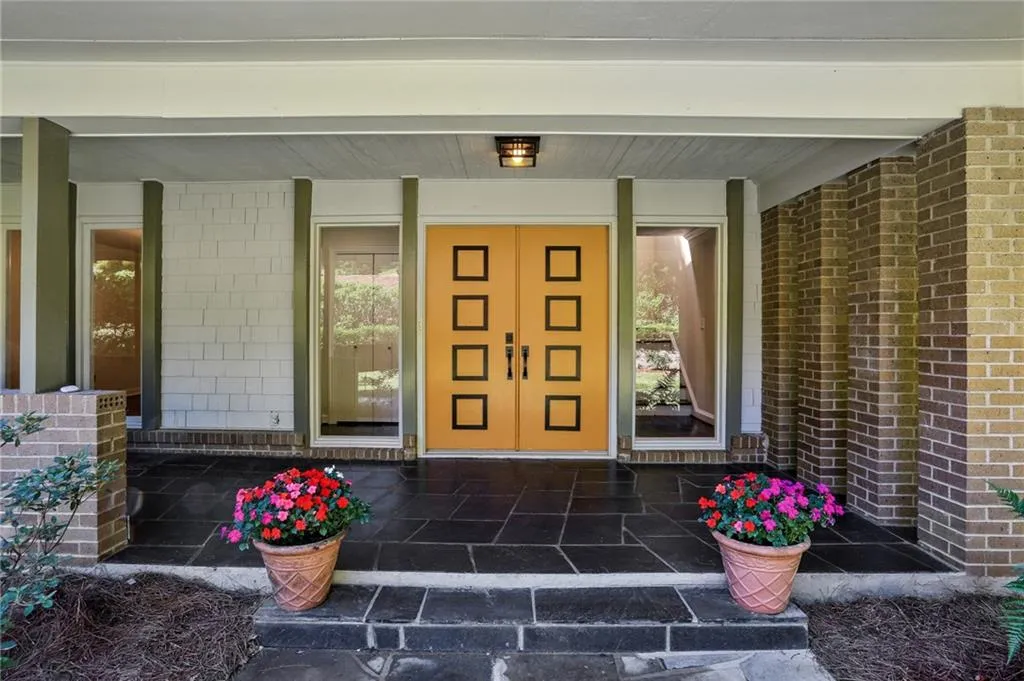 Bluestone slate entry with covered porch and decorative front doors, antique brass fixtures and 6 foot windows