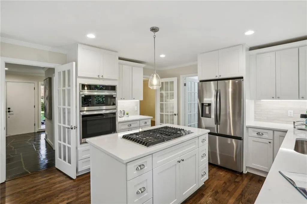 View from Kitchen showing French doors leading to hall foyer, dining room and mudroom/laundry room