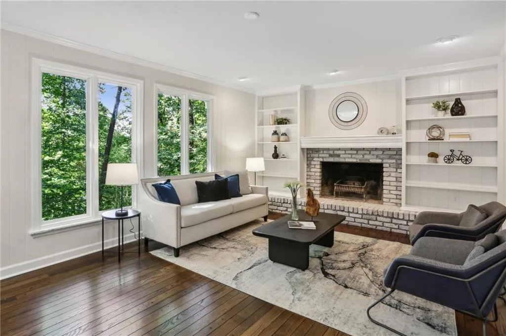 Family room with casement windows, hardwoods, woodburning fireplace and built in bookshelves