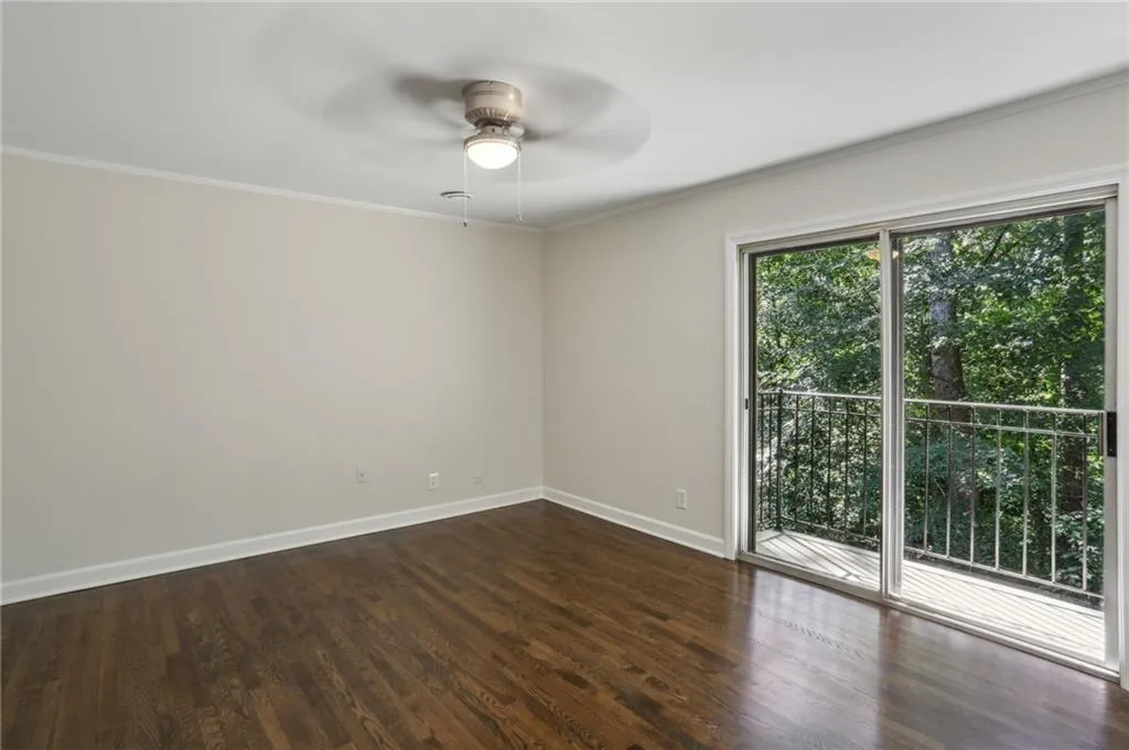 Left rear bedroom with ceiling fan, private patio and updated closet.