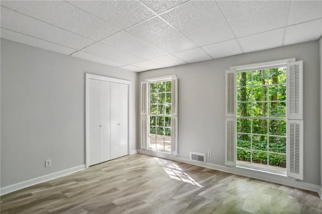 Another view of terrace level bedroom with a wealth of natural light and LVP flooring