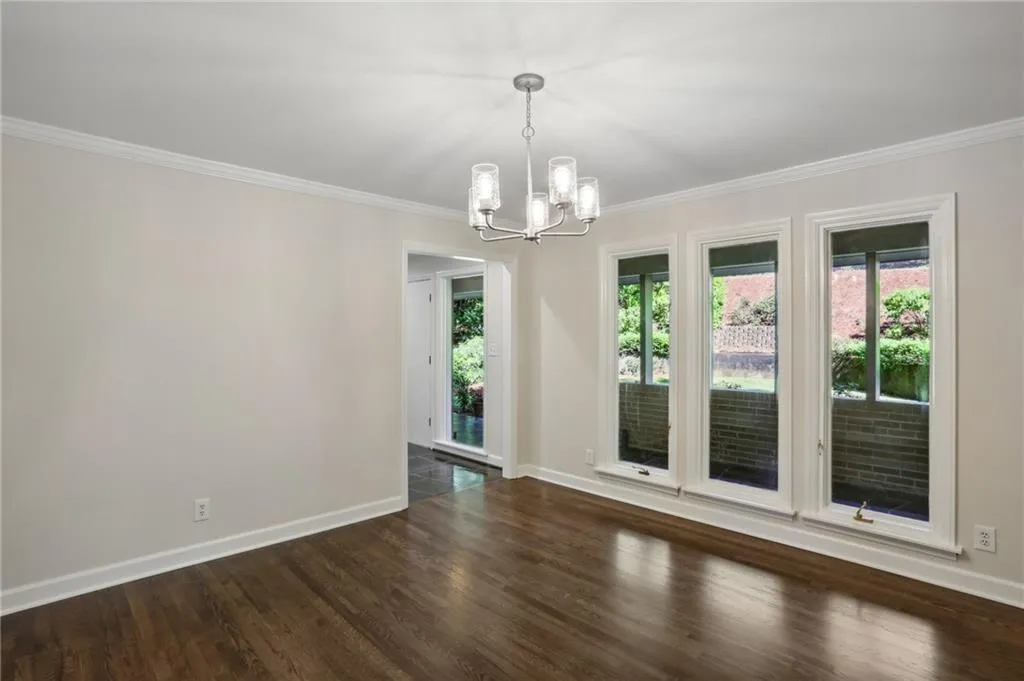 Another view of Dining room that can easily seat 12+ showing lighting and windows.