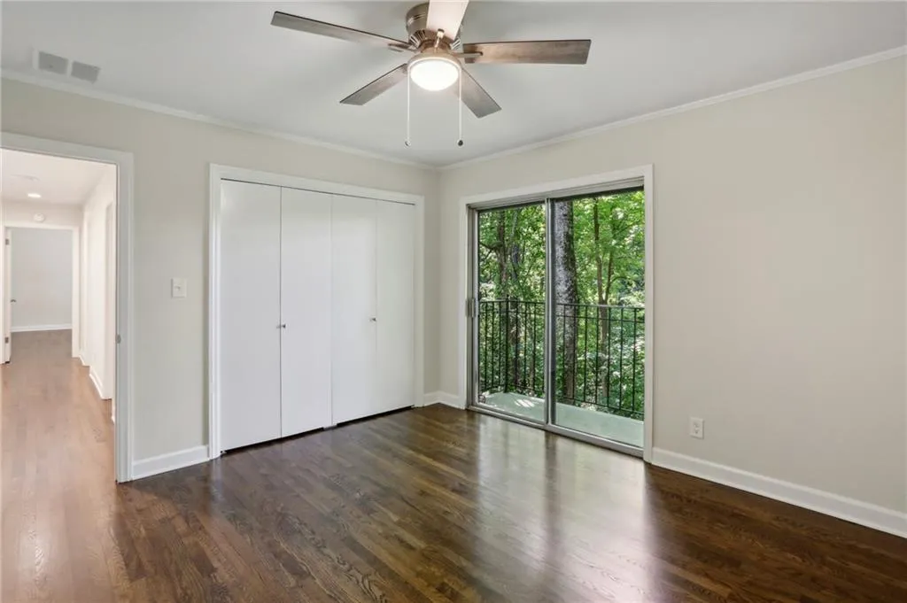 Another view of rear bedroom showing sizable closets, gleaming hardwoods and crown molding