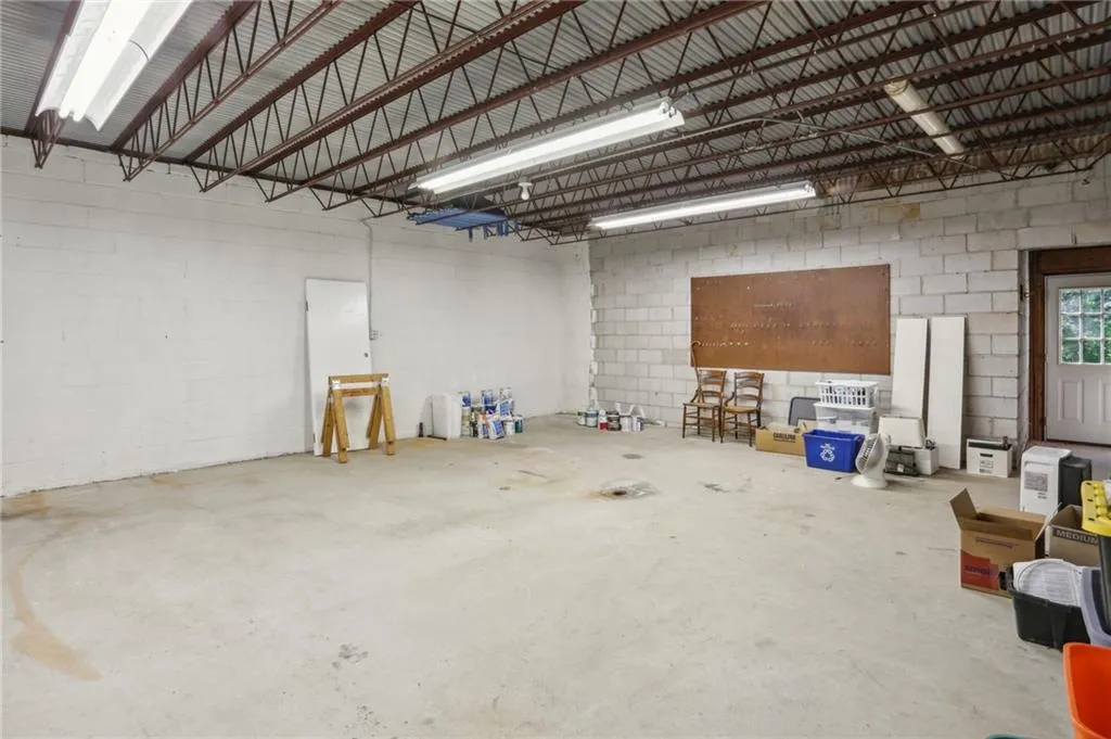 Ample storage area in unfinished basement directly below oversized garage.  Steel reinforced beams and high ceilings.  Exterior access.