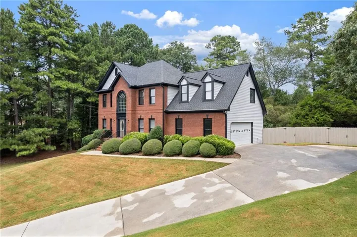 Brick facade with white siding accents and dark trim