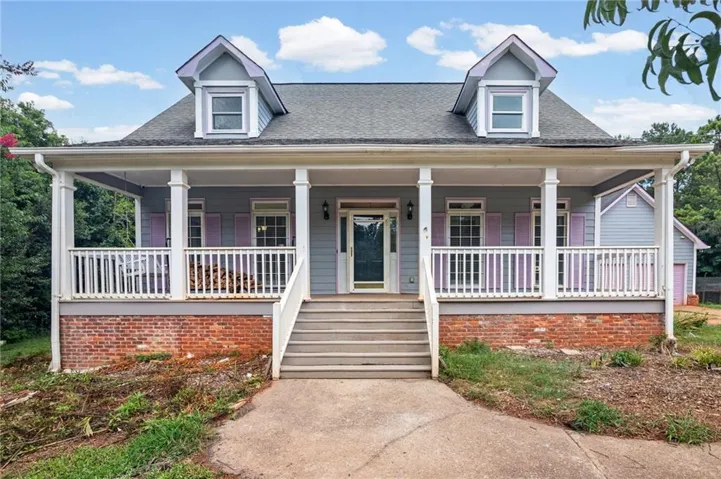 Light gray siding exterior with a welcoming full-width porch