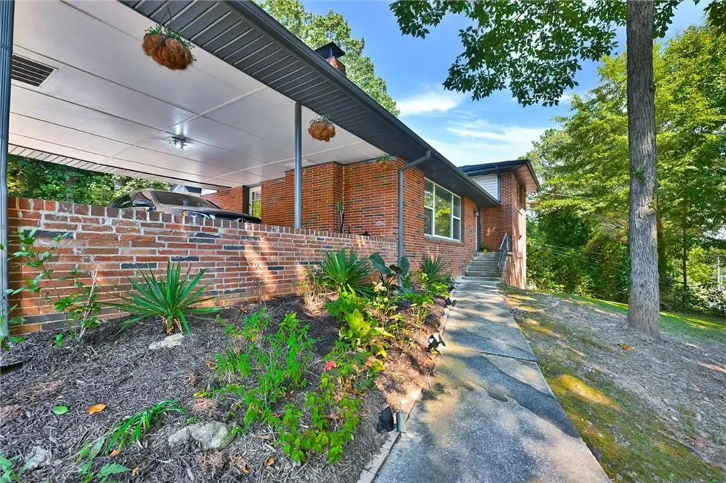 View of home's exterior with brick siding and fence