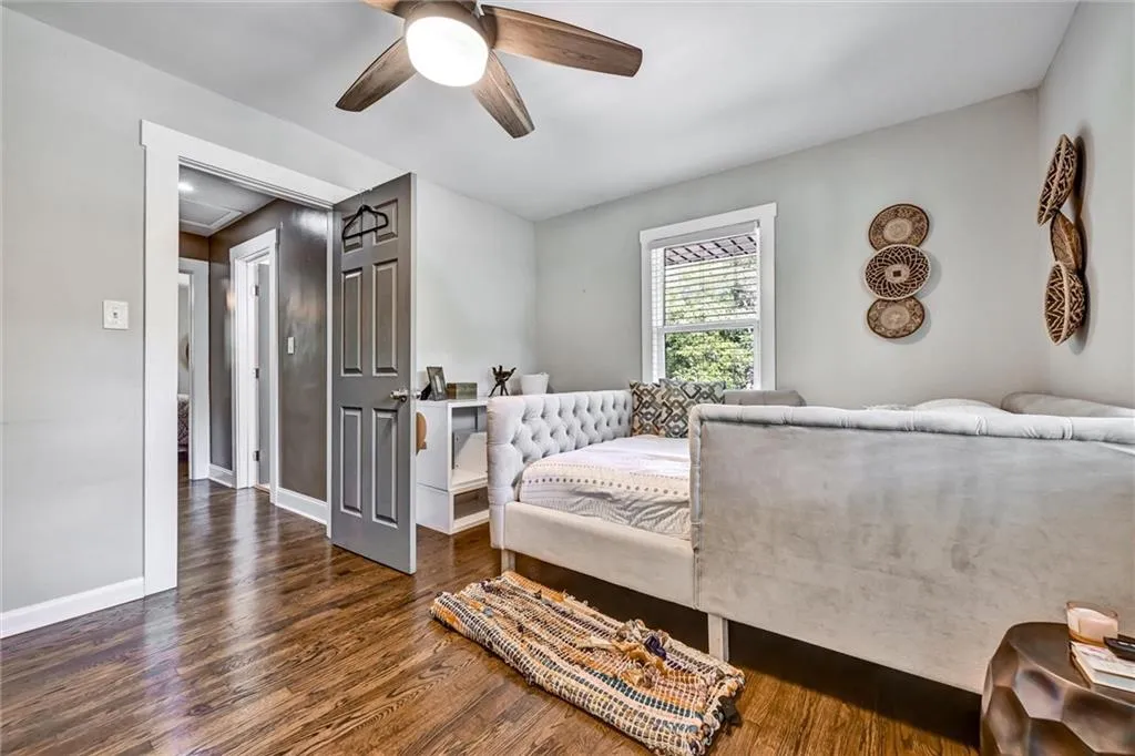 Bedroom featuring a ceiling fan, baseboards, and wood finished floors