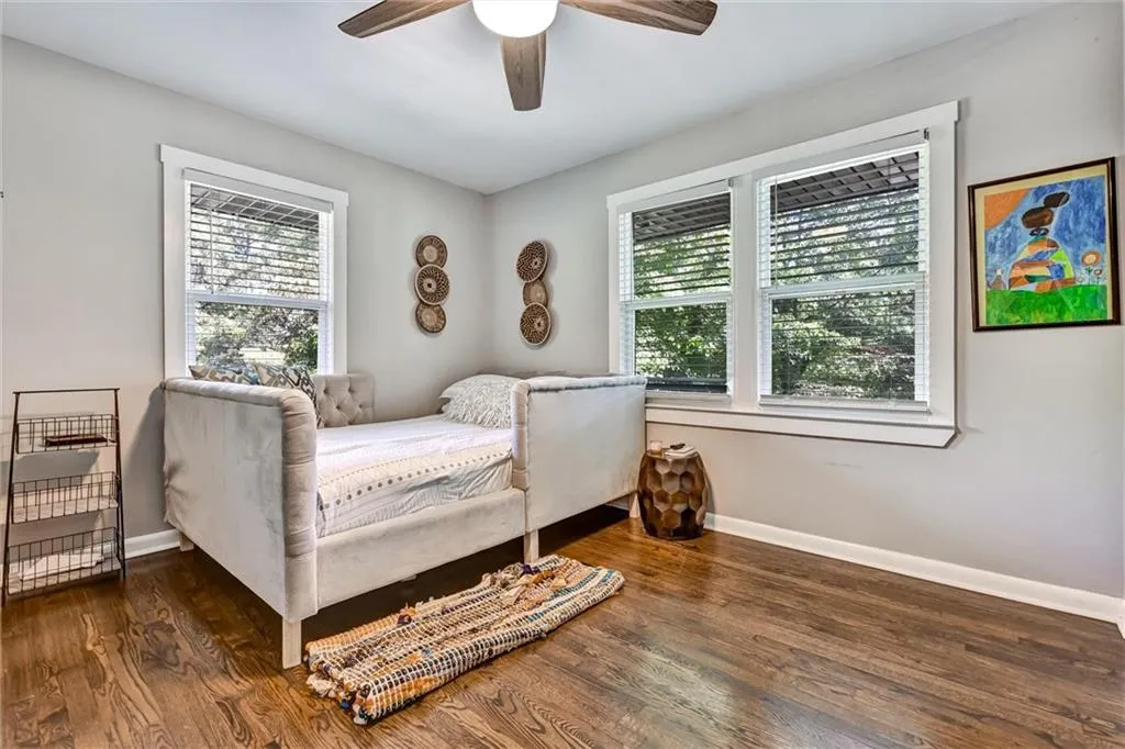 Bedroom with a ceiling fan, baseboards, and wood finished floors