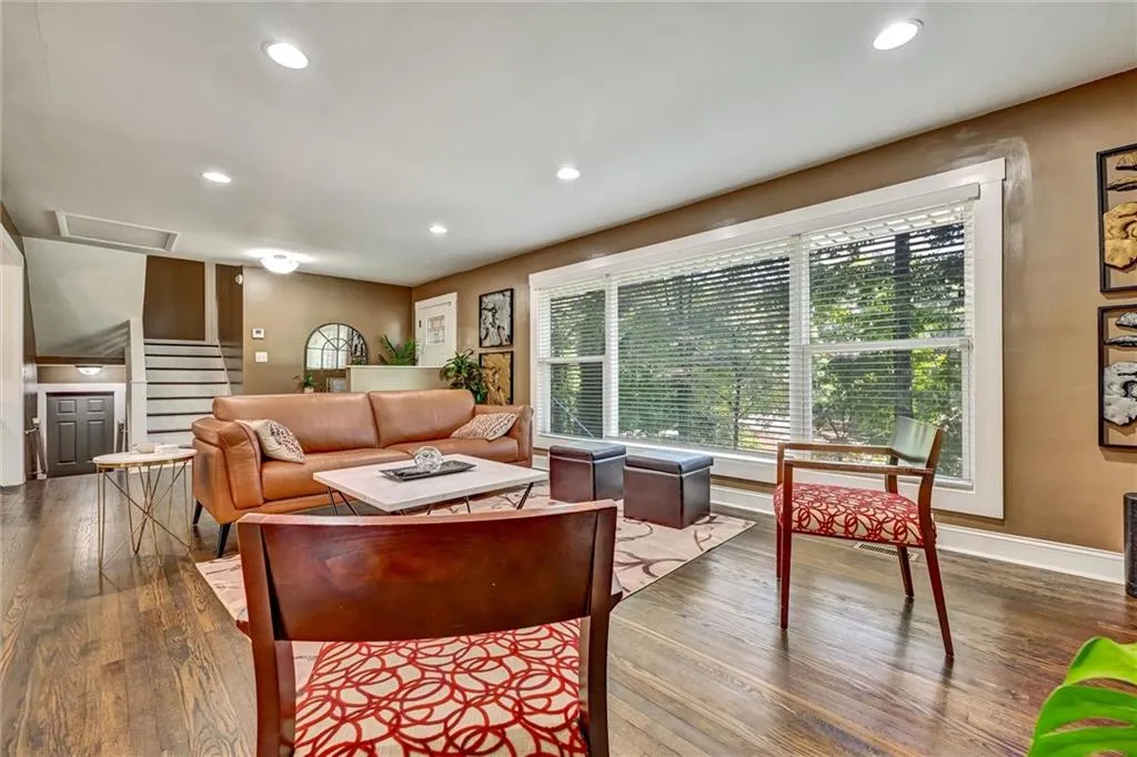 Living room featuring dark wood-style floors, stairway, baseboards, and recessed lighting