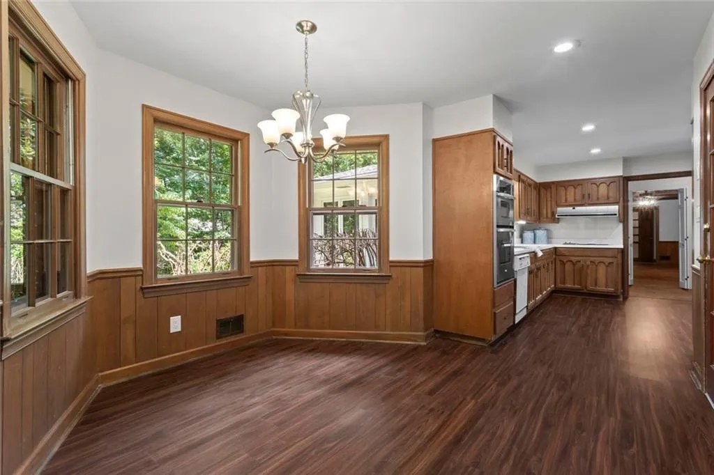 Charming breakfast nook with picture windows overlooking the backyard, offering a bright and cozy space for casual dining.