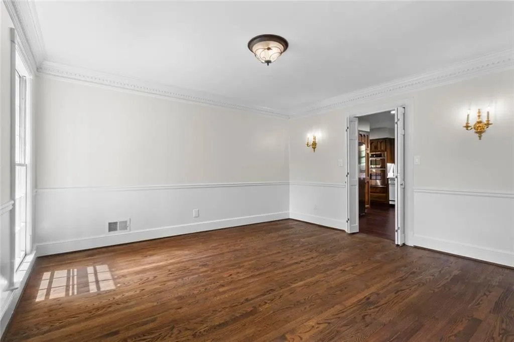 Elegant dining room featuring classic dentil molding, abundant natural light, and timeless architectural details.
