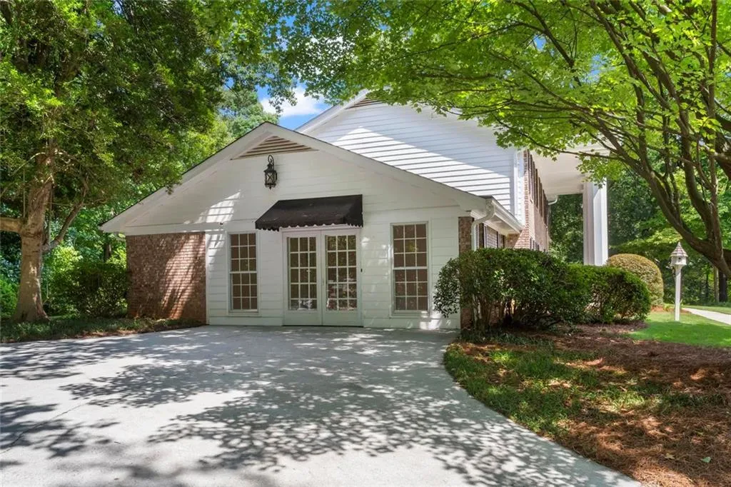Exterior of the bonus recreational room converted from the original carport, offering flexible living and entertainment space.