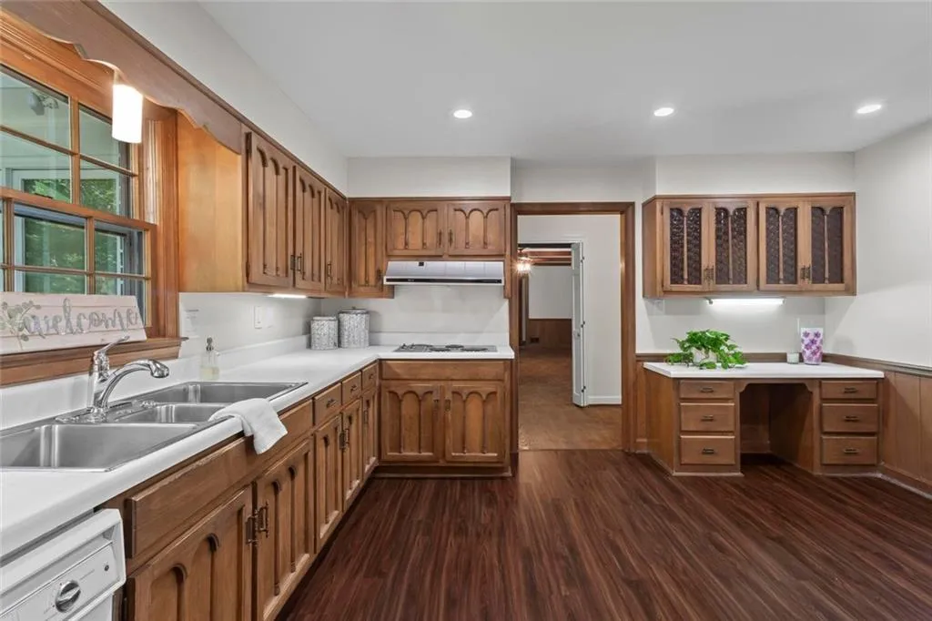 Spacious kitchen with abundant cabinetry, built-in desk, and great potential for modern updates to create your dream culinary space.