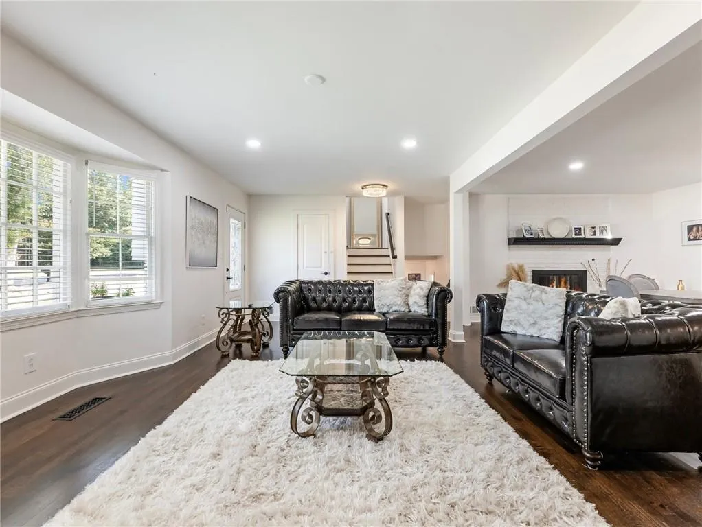 Living room with dark hardwood / wood-style flooring