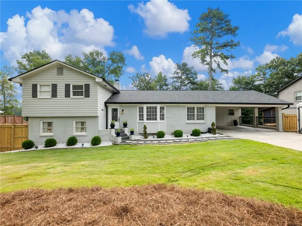 Split level home with a carport and a front yard