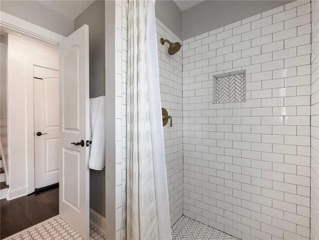 Bathroom featuring hardwood / wood-style floors and walk in shower