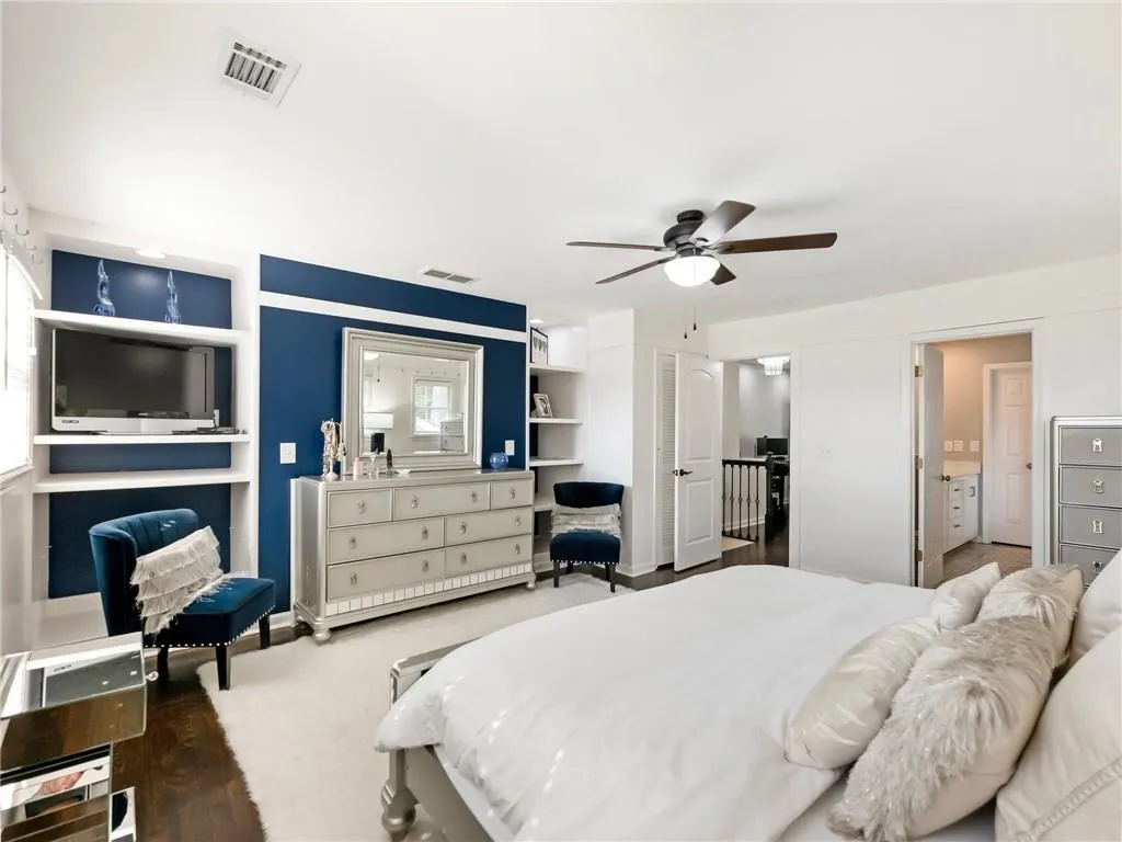 Bedroom with hardwood / wood-style floors and ceiling fan