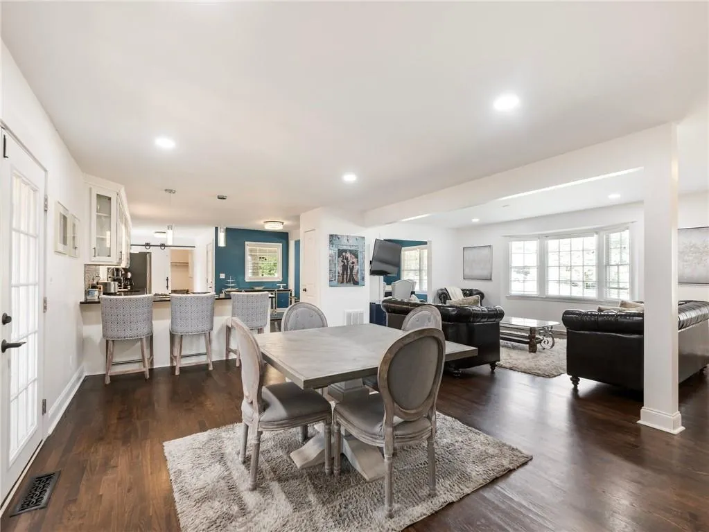 Dining space with dark wood-type flooring