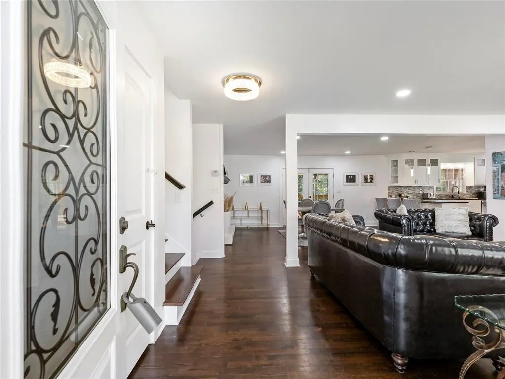 Living room with sink and dark wood-type flooring