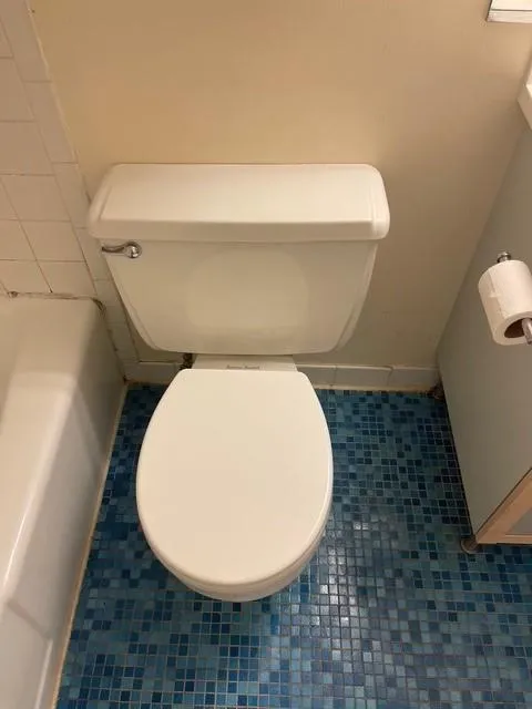 Bathroom with toilet and tile patterned flooring