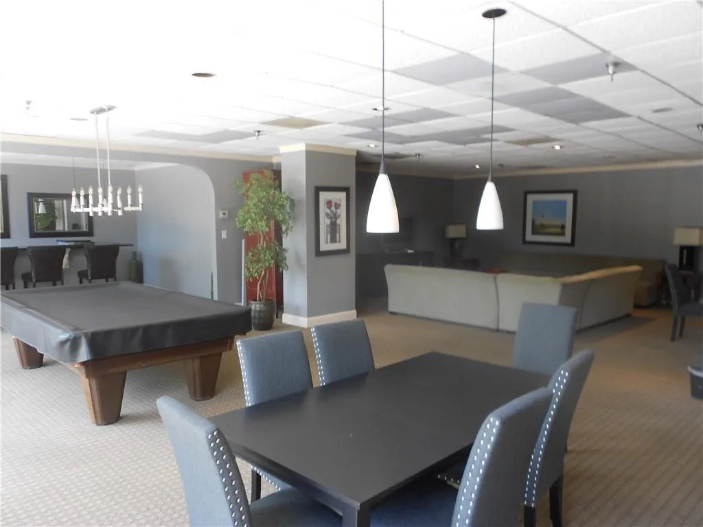 Carpeted dining room with billiards and a paneled ceiling