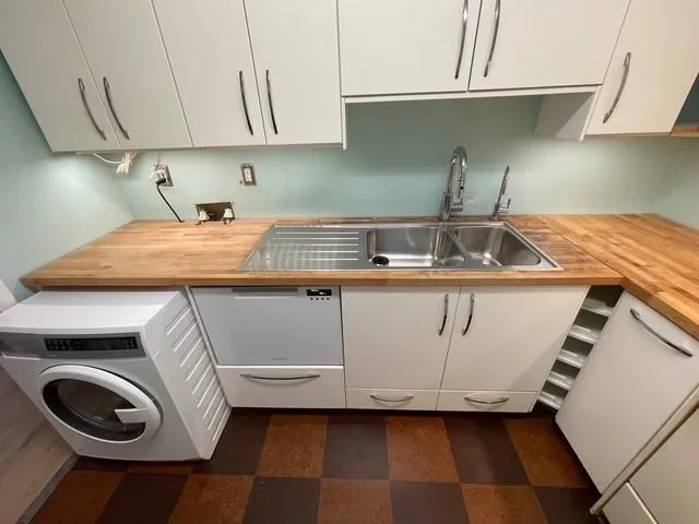 Clothes washing area featuring sink and washer / clothes dryer