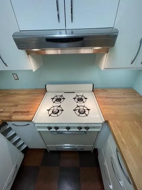 Kitchen featuring stove and butcher block counters