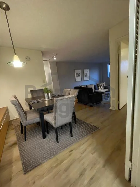 Dining room with wood finished floors.Look at AI Staging what thing could be like with a vision!