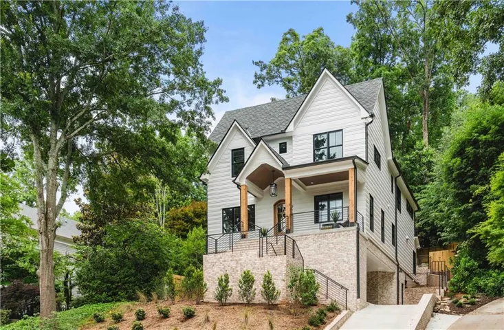 Modern farmhouse architecture with white horizontal siding and black-framed windows