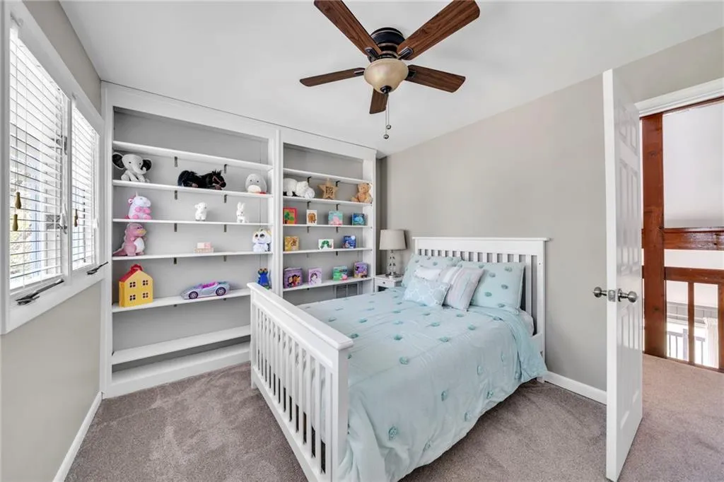 Bedroom featuring light colored carpet and ceiling fan