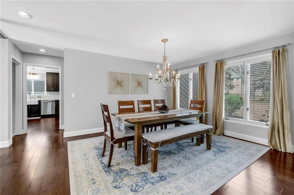 Dining area featuring an inviting chandelier and dark hardwood / wood-style flooring