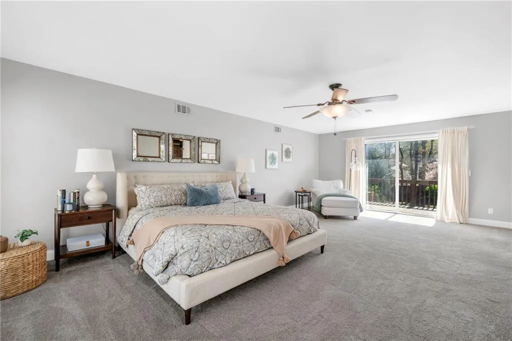 Bedroom with carpet floors, access to outside, and ceiling fan