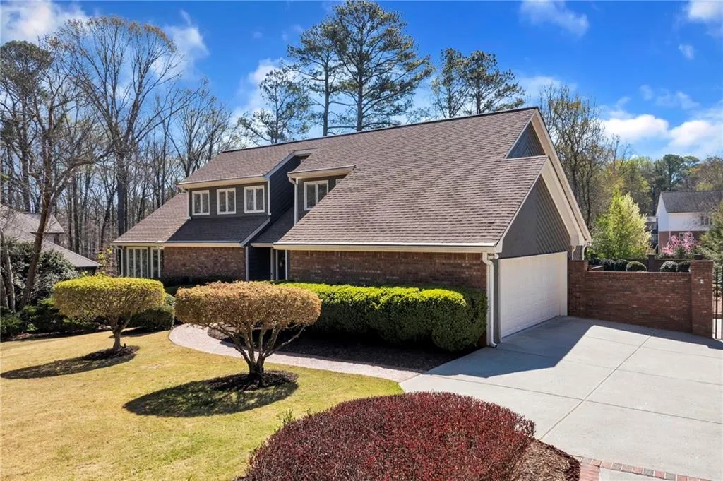 View of front of house with a front lawn and a garage
