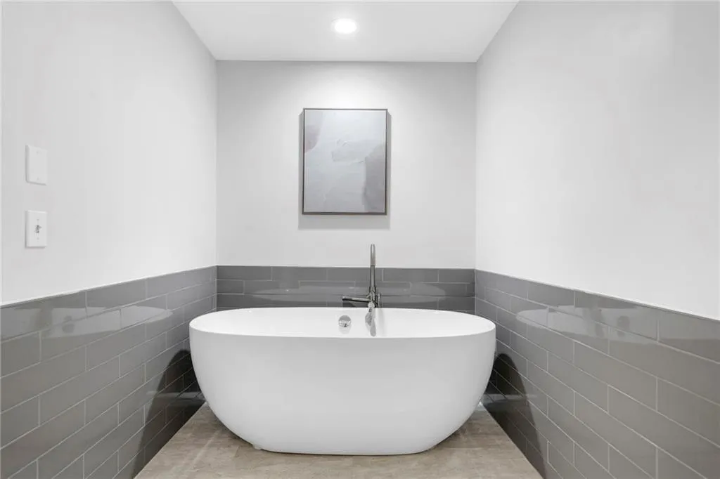 Bathroom featuring tile flooring and tile walls
