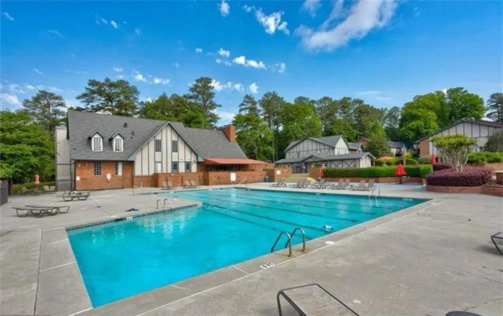Community pool with a patio