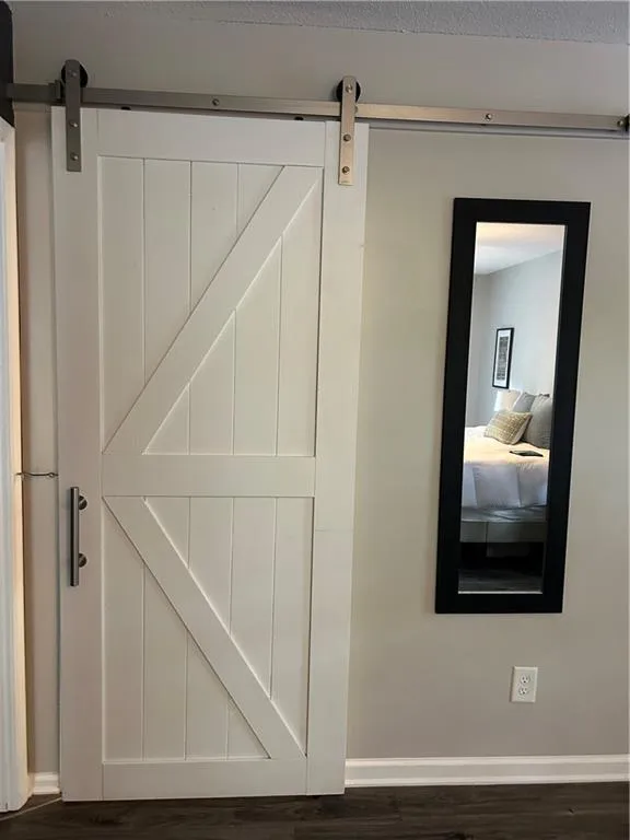 Detailed view of a barn door and wood finished floors
