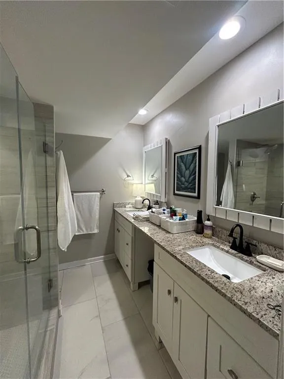 Bathroom featuring a stall shower and vanity