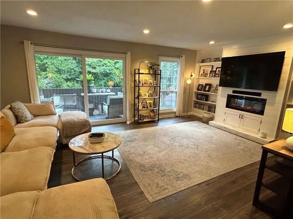 Living room with recessed lighting and dark wood-type flooring