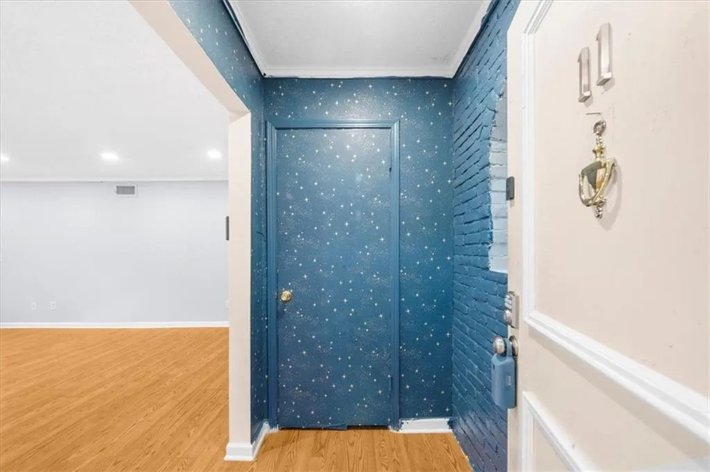 Hall with wood-type flooring and ornamental molding Hall with wood-type flooring and ornamental molding