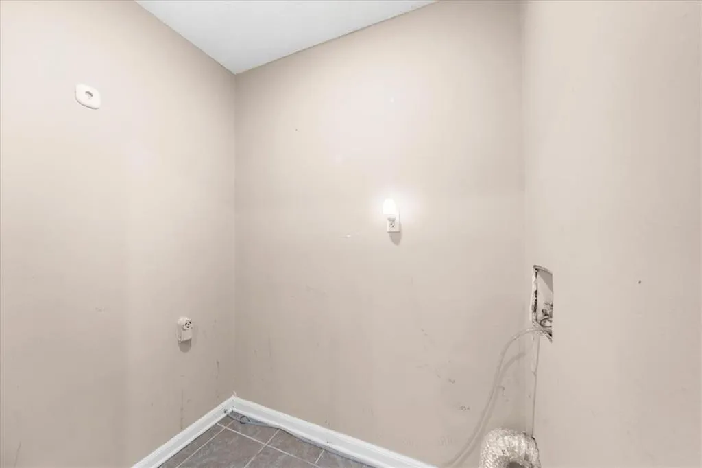 Clothes washing area with tile patterned flooring Clothes washing area with tile patterned flooring