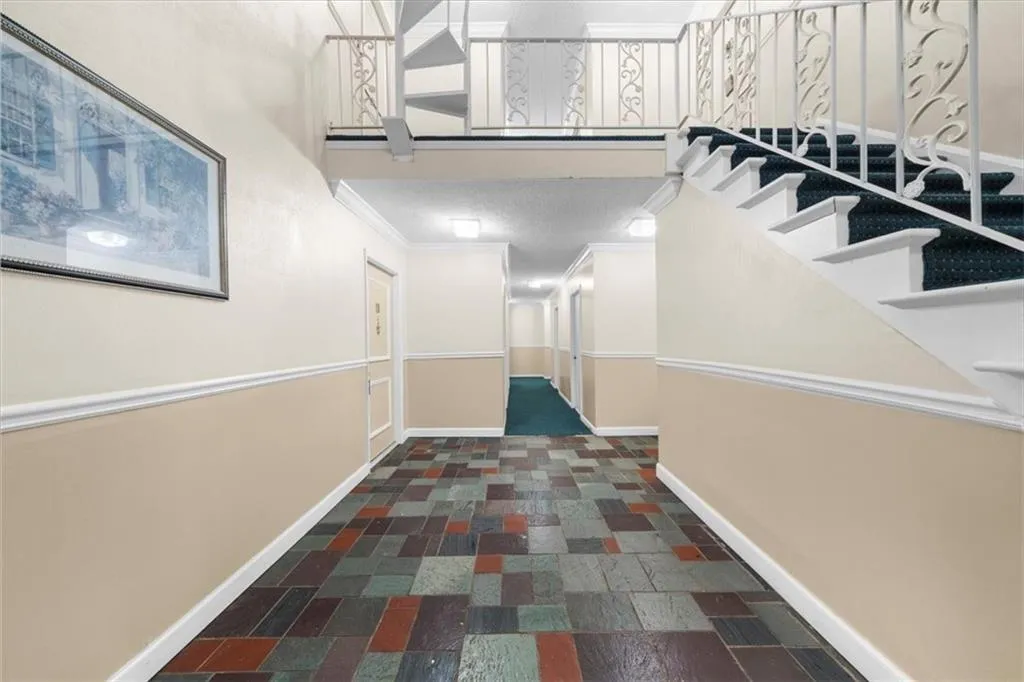 Hallway featuring ornamental molding Hallway featuring ornamental molding