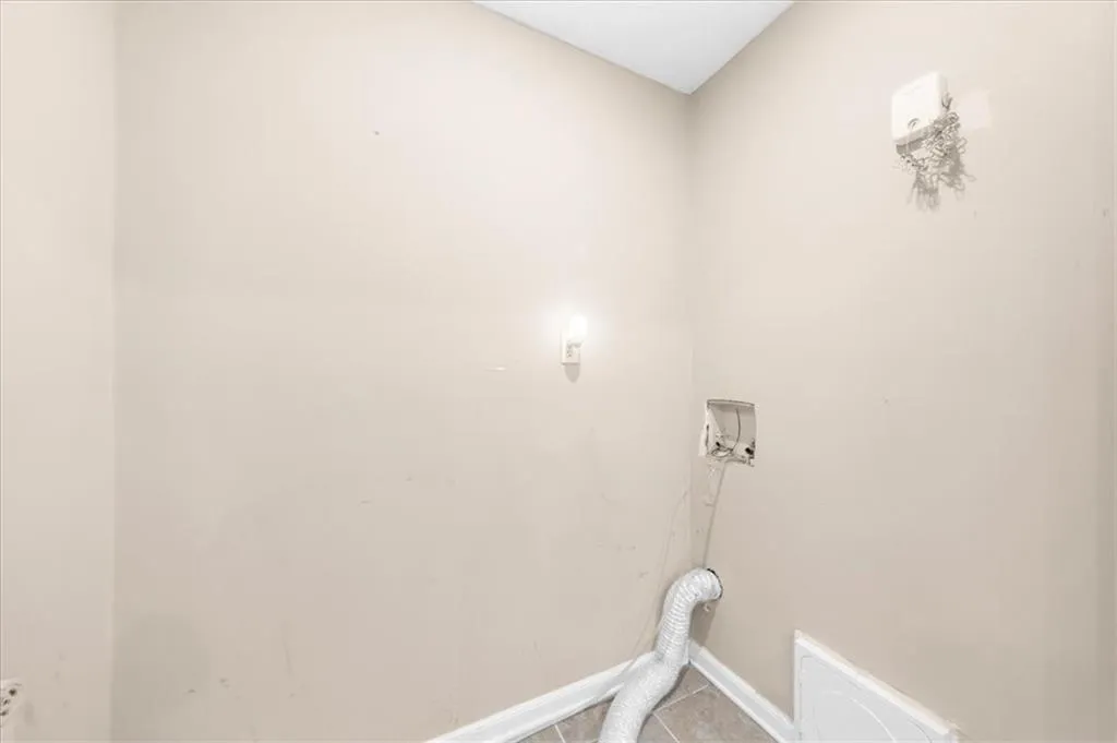 Laundry room featuring light tile patterned floors Laundry room featuring light tile patterned floors