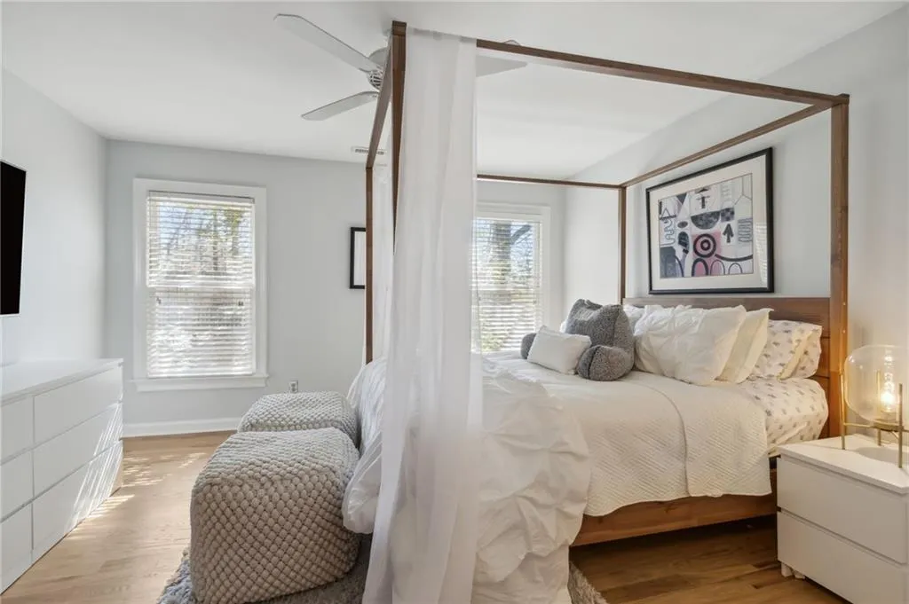 Bedroom featuring multiple windows, light wood-type flooring, and ceiling fan