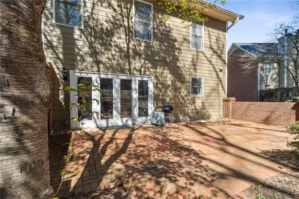 Rear view of property featuring a patio area and french doors