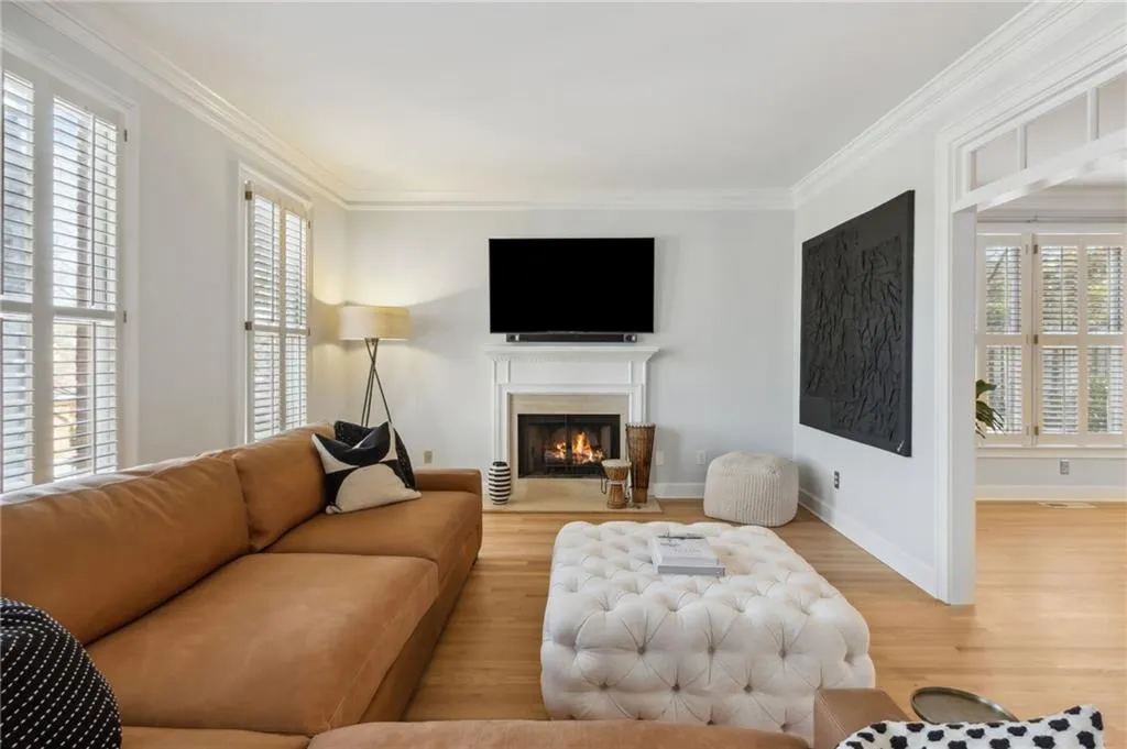 Living room featuring crown molding and light wood-type flooring