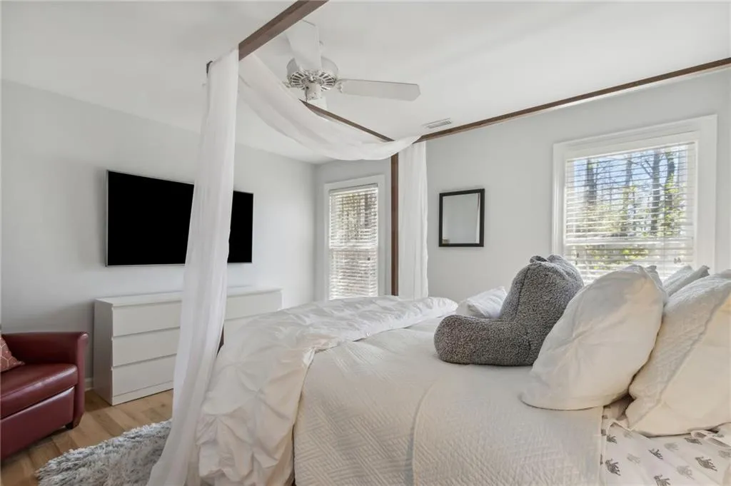 Bedroom featuring ceiling fan and light hardwood / wood-style flooring
