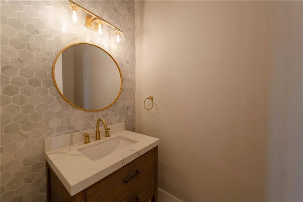 Bathroom featuring vanity and tile walls